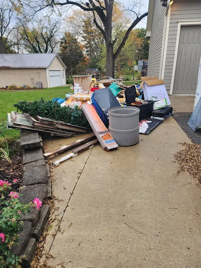 Dumpster being loaded with debris for Estate Cleanout Dumpster Rental in Jacksonville